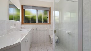 A modern bathroom with a large window, a shower, and a toilet. - Canyon Walk House and Unit - Located in the heart of Bright (Bright)