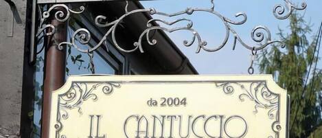 A sign for 'Les Jardins Carol Boutique Hotel' and 'Il Cantuccio Ristorante'.
