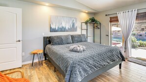A bedroom with a bed, a ceiling fan, a window with curtains, and a door. - 2 Mi to Lake Havasu: Poolside Paradise! (Lake Havasu City)
