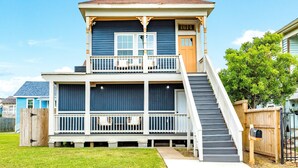 A two-story house with a front porch, a staircase, and a mailbox.