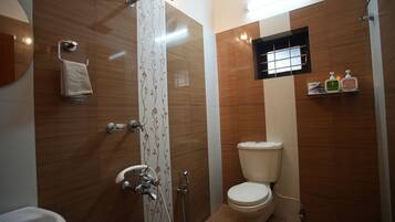 A modern bathroom with a shower, toilet, and sink.