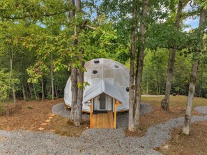 A geodesic dome structure with a wooden entrance and a number '759' on the door. - Nottely River Retreat | Fire Pit (Murphy)