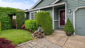 A house with a well-maintained garden, a stone pathway, and a mailbox. - Fantastic Single Level Ranch Layout, Fenced Backyard w/ Large Deck, New Decor and Furnishing (Hillsboro)