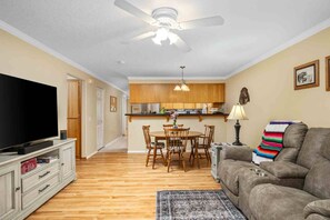 A living room with a TV, sofa, and dining area. - Fantastic Single Level Ranch Layout, Fenced Backyard w/ Large Deck, New Decor and Furnishing (Hillsboro)