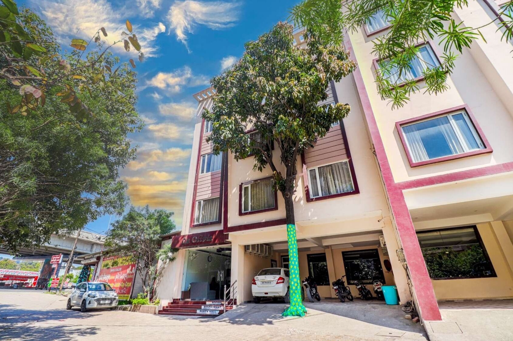A multi-story hotel with a parking garage, a restaurant, and a party hall.
