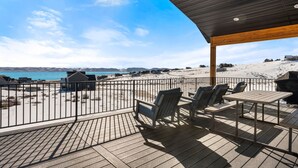 A deck with outdoor seating overlooking a beach. - The Azure View - Sleeps 25 - Pickleball - POOL (Fish Haven)