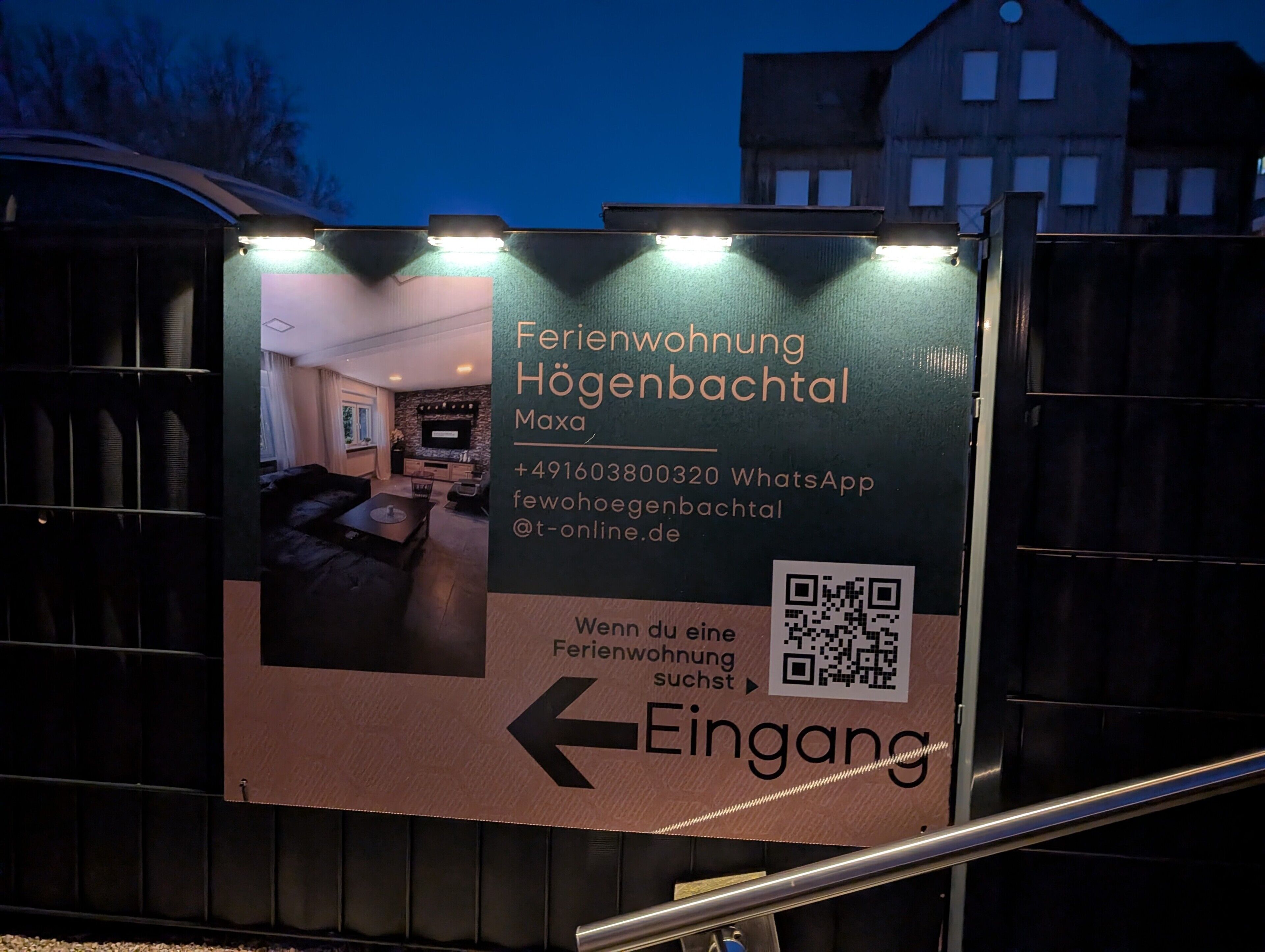 A sign for a hotel with a QR code, contact information, and an arrow pointing left.