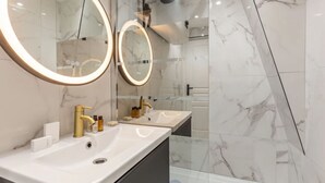 A modern bathroom with two sinks, large mirrors, and marble walls. - 21.#Opera#Louvre#Paris02#2bedrooms#AC (Paris)