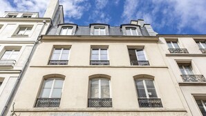 A multi-story building with a classic architectural style, featuring arched windows and decorative balconies. - A1.RépubliqueMarais1BedRoomParis03AC (Paris)