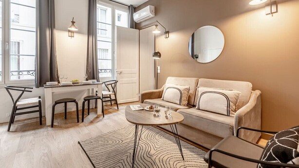 A modern living room with a sofa, coffee table, and dining area. - A1.RépubliqueMarais1BedRoomParis03AC (Paris)