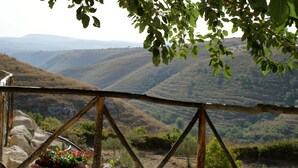 Une vue d’un paysage montagneux, avec une clôture en bois au premier plan.