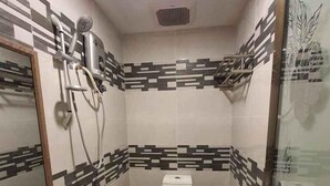 A compact bathroom with a toilet, a shower, and a sink. - Enrich Hotel Puncak Alam by uBook (Ijok)