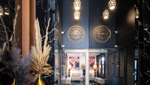 A luxurious lobby with a black and white marble floor, gold accents, and modern lighting fixtures. - Lazuli Hermes Apartments (Larnaca)