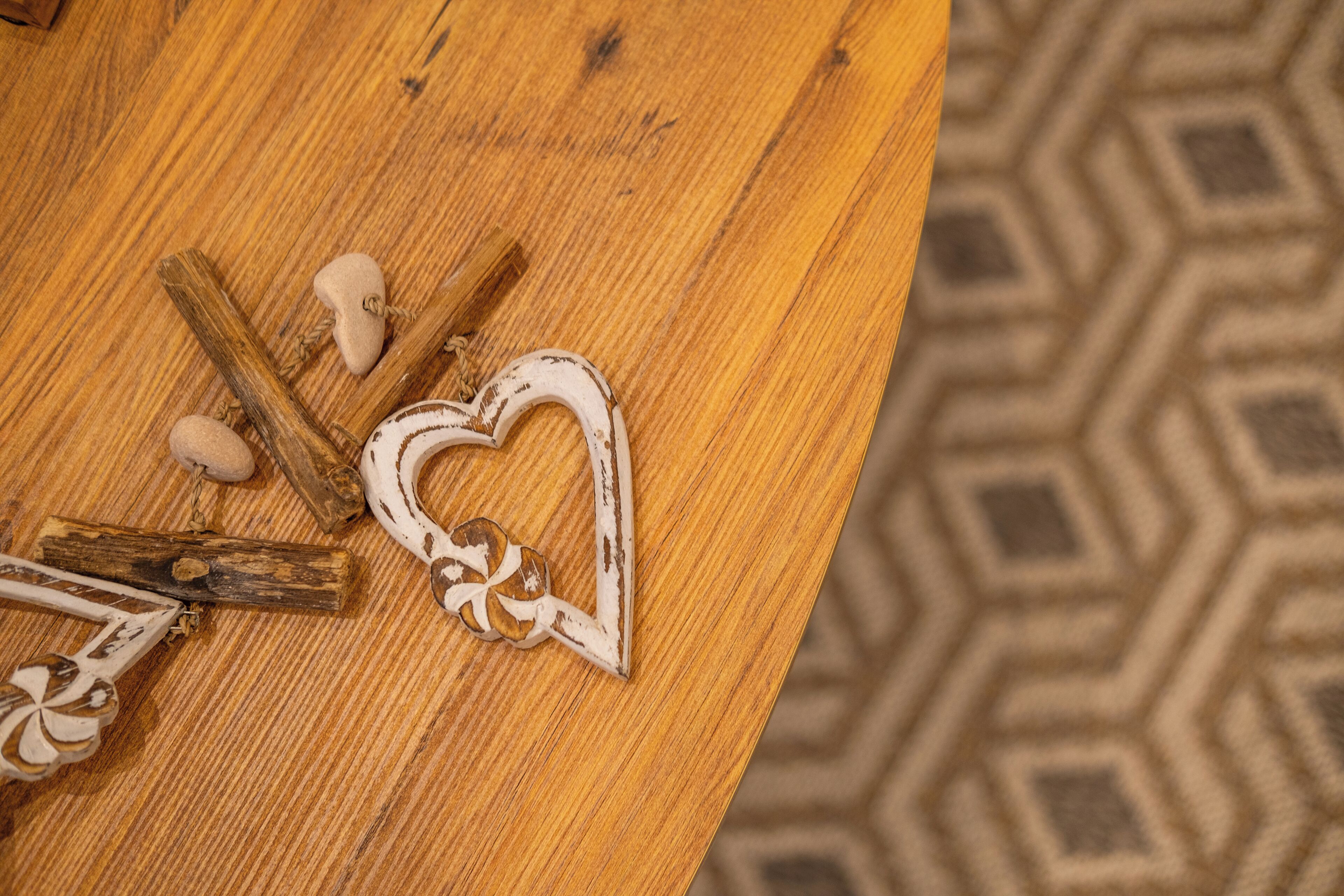 A wooden table with a heart-shaped decoration and a rustic charm.