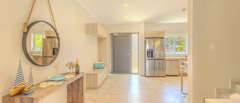 A spacious kitchen with modern appliances and a wooden counter.
