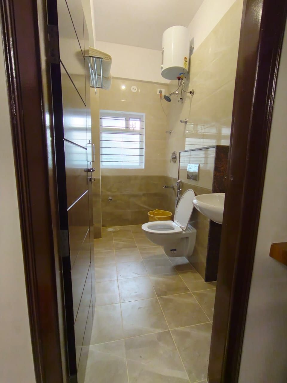 A bathroom with a toilet, sink, and shower.