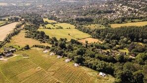 An aerial view of a rural area with fields, houses, and a small village.