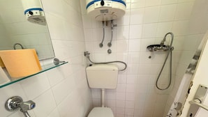 A small, tiled bathroom with a toilet, bidet, and sink. - Studio apartment Šarić 3 (Kraljevica)