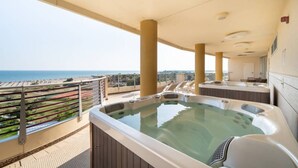 A rooftop terrace with a hot tub, a view of the sea, and a bar area. - Beachfront room with pool and sun deck (Bibione)