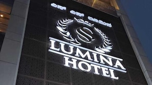 The exterior of the LUMINA HOTEL with signage for the Royal Rajasthan Thai Restaurant and a Toilet Saar sign. - SS LUMINA HOTEL (Bengaluru)
