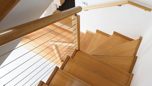 A wooden staircase with a metal handrail and a white wall. - Cameron Mews: In The Heart Of The City (Launceston City)