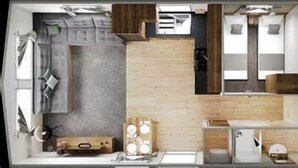 A modern hotel room with a large bed, a small desk, a wardrobe, and a bathroom.