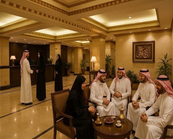 A formal meeting room with a reception desk, potted plants, and a framed Arabic calligraphy piece on the wall.