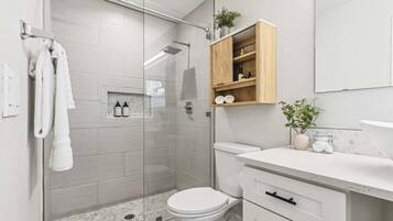 Shower, hair dryer, towels, shampoo