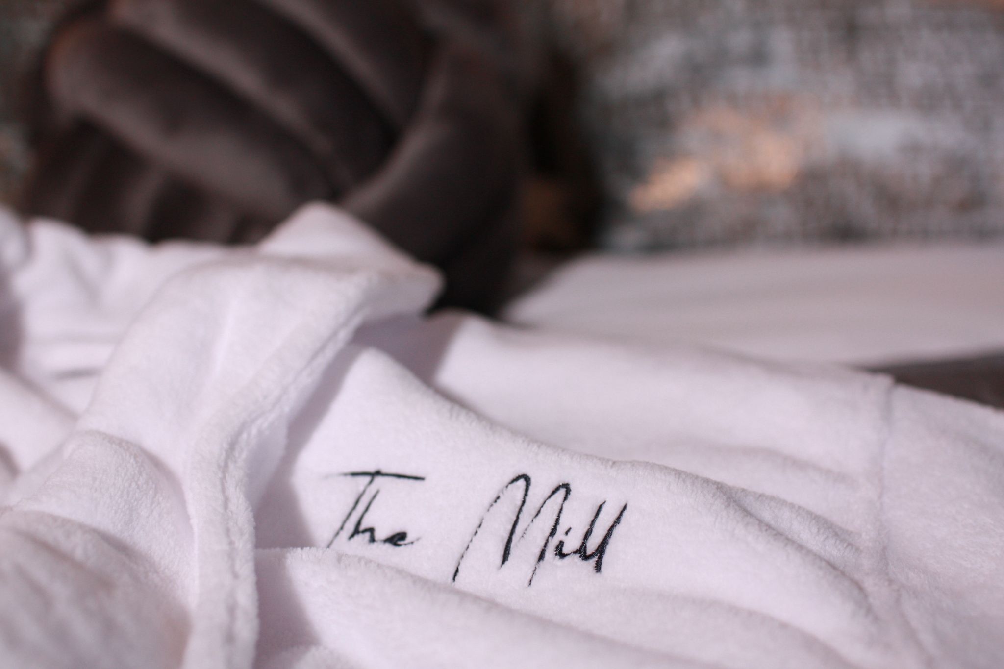 A white towel with the text "The Mill" written on it.