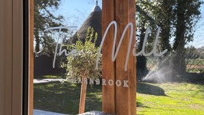 A wooden structure with the text "The Mill" and "SHARNBROOK" visible. - The Mill Sharnbrook (Bedford)