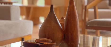 A glass-top table with ceramic vases and bowls.