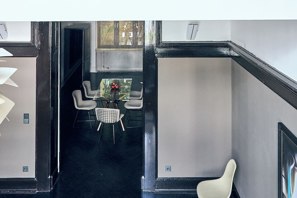 A modern interior with a glass staircase connecting two floors.