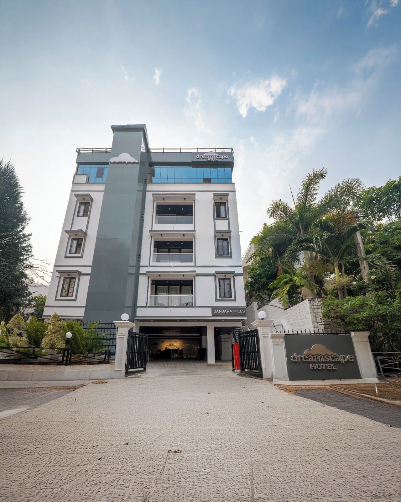 A multi-story hotel with a modern facade, a prominent entrance, and a sign indicating the hotel name.