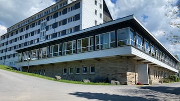 Stunning corner building with large windows, stone and wood paneling, and a flat roof.