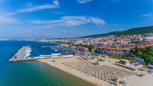 A coastal town with a marina, beach, and residential buildings. - Sea Vista Hotel (Sveti Vlas)