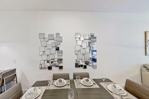 A clean, inviting dining space that flows perfectly into the kitchen and living room