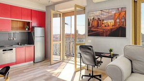 A modern apartment with a kitchen, dining area, and a balcony with a cityscape view. - Stylish 2BR flat next to Navigli (Milan)
