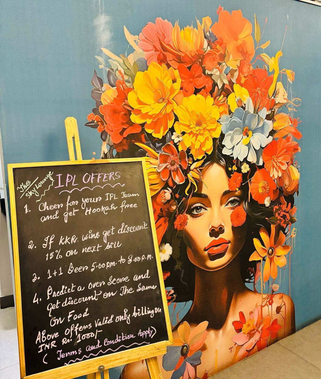 A chalkboard with IPL offers including discounts on food and drinks.