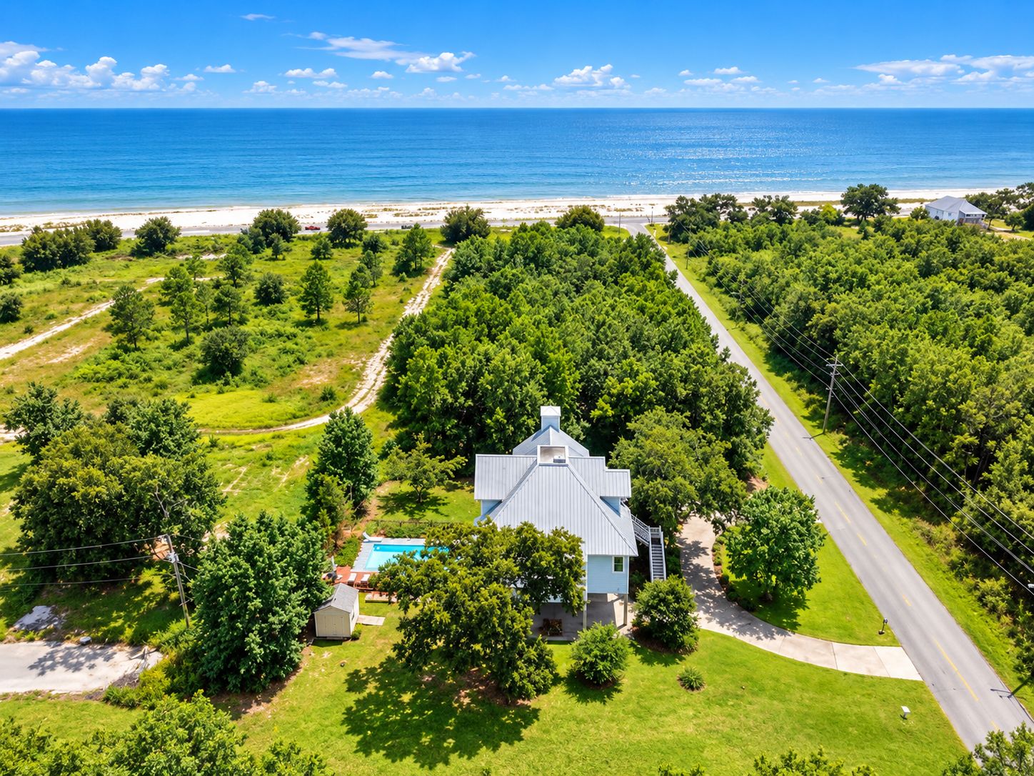 Private coastal retreat with pool, lush grounds, and easy beach access