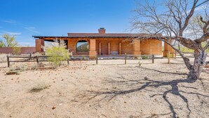 A brick building with a large arched doorway and a wooden fence in front. - 10-acre Desert Oasis w/ Expansive Patio in Tucson! (Tucson)
