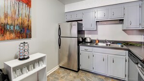 A kitchen with grey cabinets, a stainless steel refrigerator, a sink, and a coffee machine. - 1 Mi to Dtwn: Pet-friendly Apt in Nashville (Nashville)