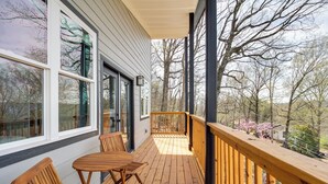 A wooden deck with a table and chairs, overlooking a forested area. - 6 Mi to Chattanooga: Home w/ Balcony & Dtwn Views! (Rossville)
