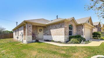 Situated in a quiet suburban neighborhood, this house offers a charming front entrance with a door and small porch area.
