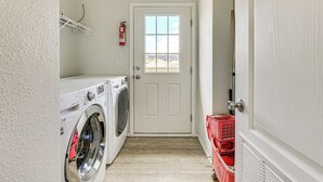 A laundry room with a washing machine, dryer, and a fire extinguisher on the wall. - Near Ramona Wineries: Mtn-view Haven w/ Large Yard (Ramona)