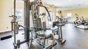 A gym with various exercise machines, a treadmill, and a sign indicating the use of dumbbells. - 6 Mi to Myrtle Beach Hot Spots: Cozy Condo! (Socastee)