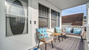 A porch with a checkered mat, wicker chairs with patterned cushions, and a bench with cushions. - Walk to Brigantine Beach: Home w/ BBQ & Yard (Brigantine)