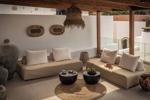 Relax in style with two sofas facing a spacious outdoor terrace.
