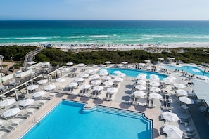 A resort with multiple swimming pools, sun loungers, and umbrellas.