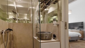 A modern bathroom with a large mirror, a stone sink, and a shower enclosure. - Acropolis Hideaway Studio by GHH (Athina)