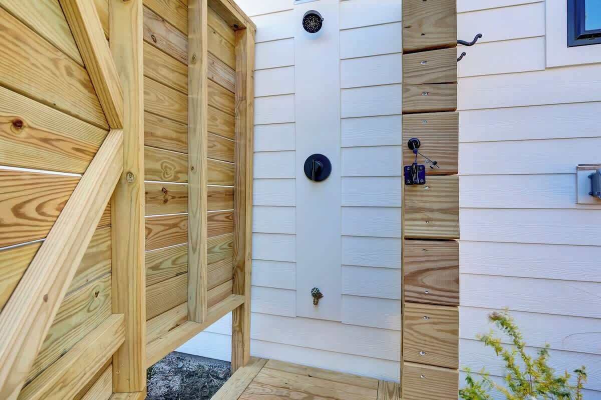 A wooden fence with a door, a window, and a mailbox.